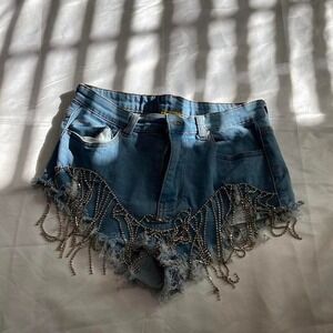 Light wash blue denim shorts with dramatic silver rhinestone fringe detailing.
